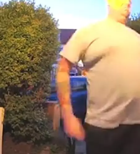 The man can be seen grabbing the pensioner away from his house.