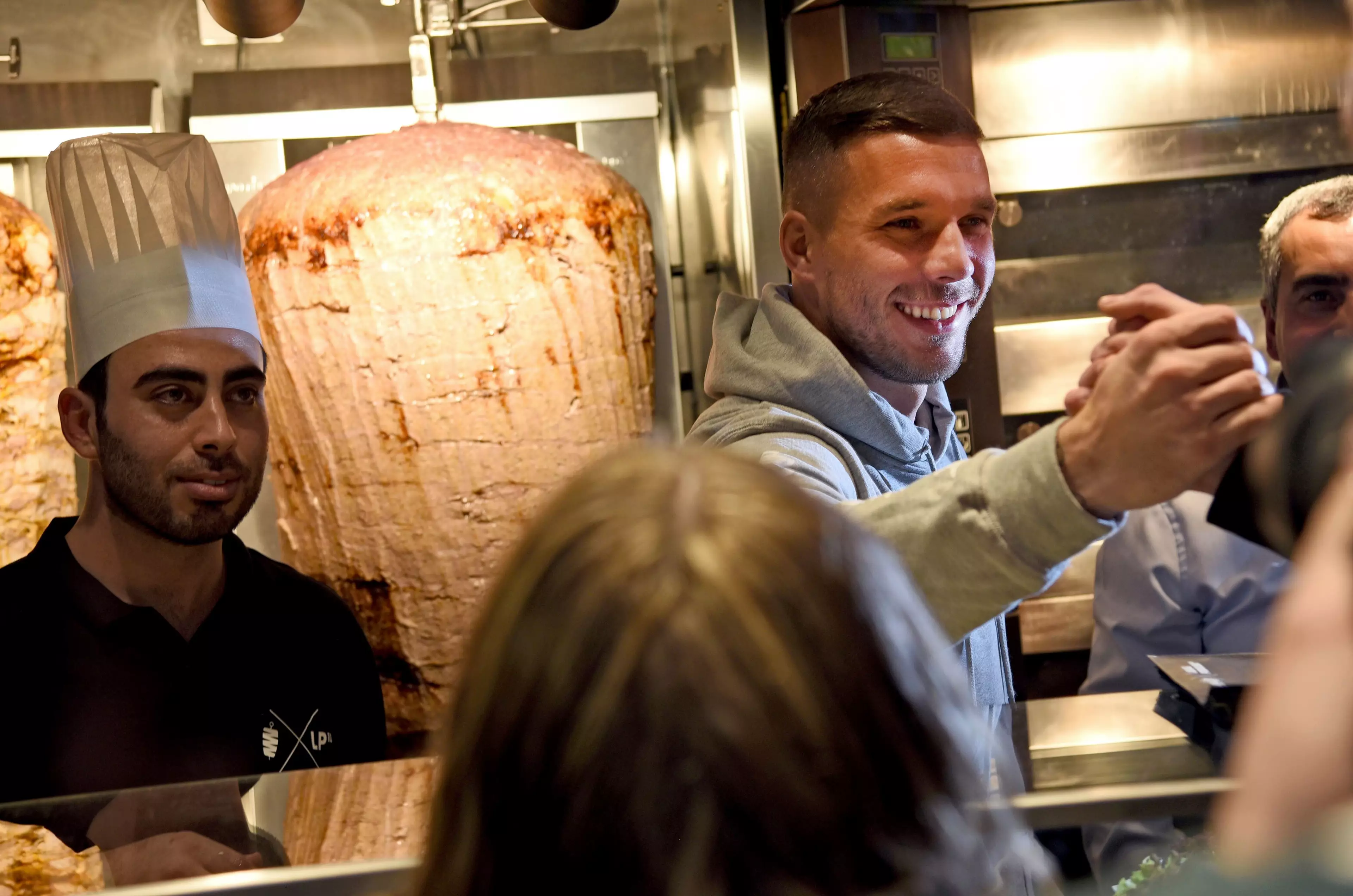 Podolski serves the people what they want. Image: PA Images.