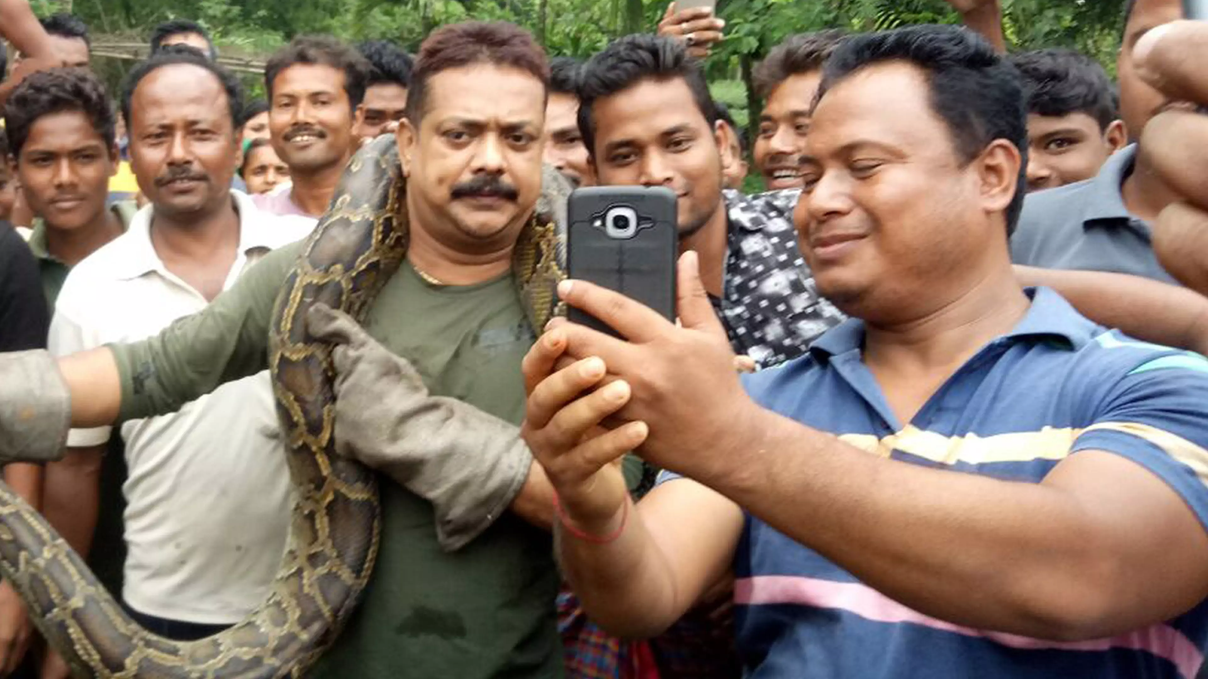 Huge Python Tries To Strangle Indian Forest Ranger Posing For Photos