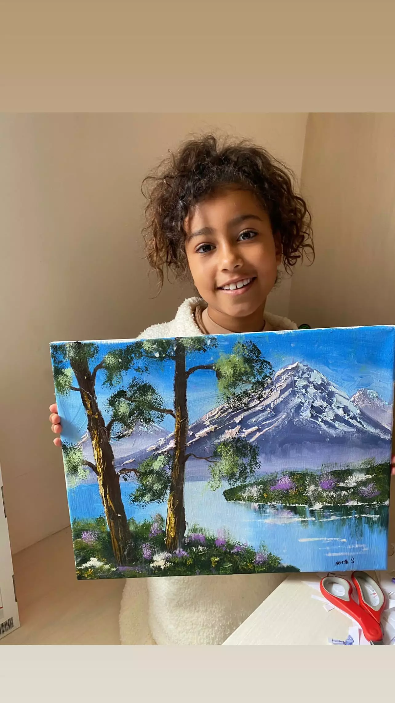 Kim posted North holding her little masterpiece (