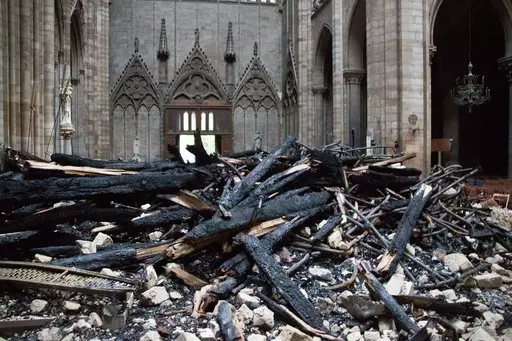 A picture taken on April 16, 2019 shows the altar surrounded by charred debris inside the Notre-Dame Cathedral.