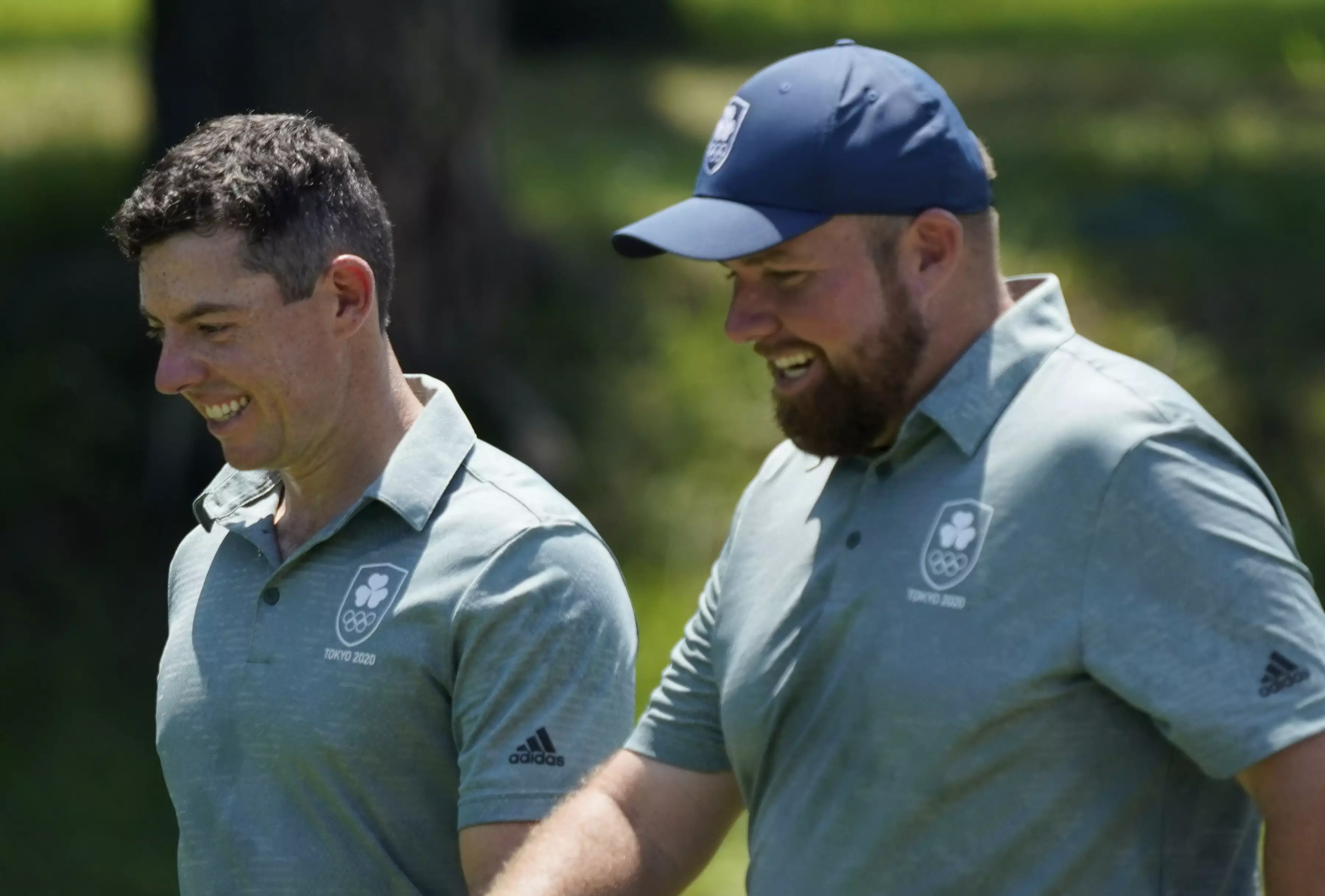 Rory McIlroy and his teammate Shane Lowry speak during a practice round of the men's golf event at the 2020 Summer Olympics. (
