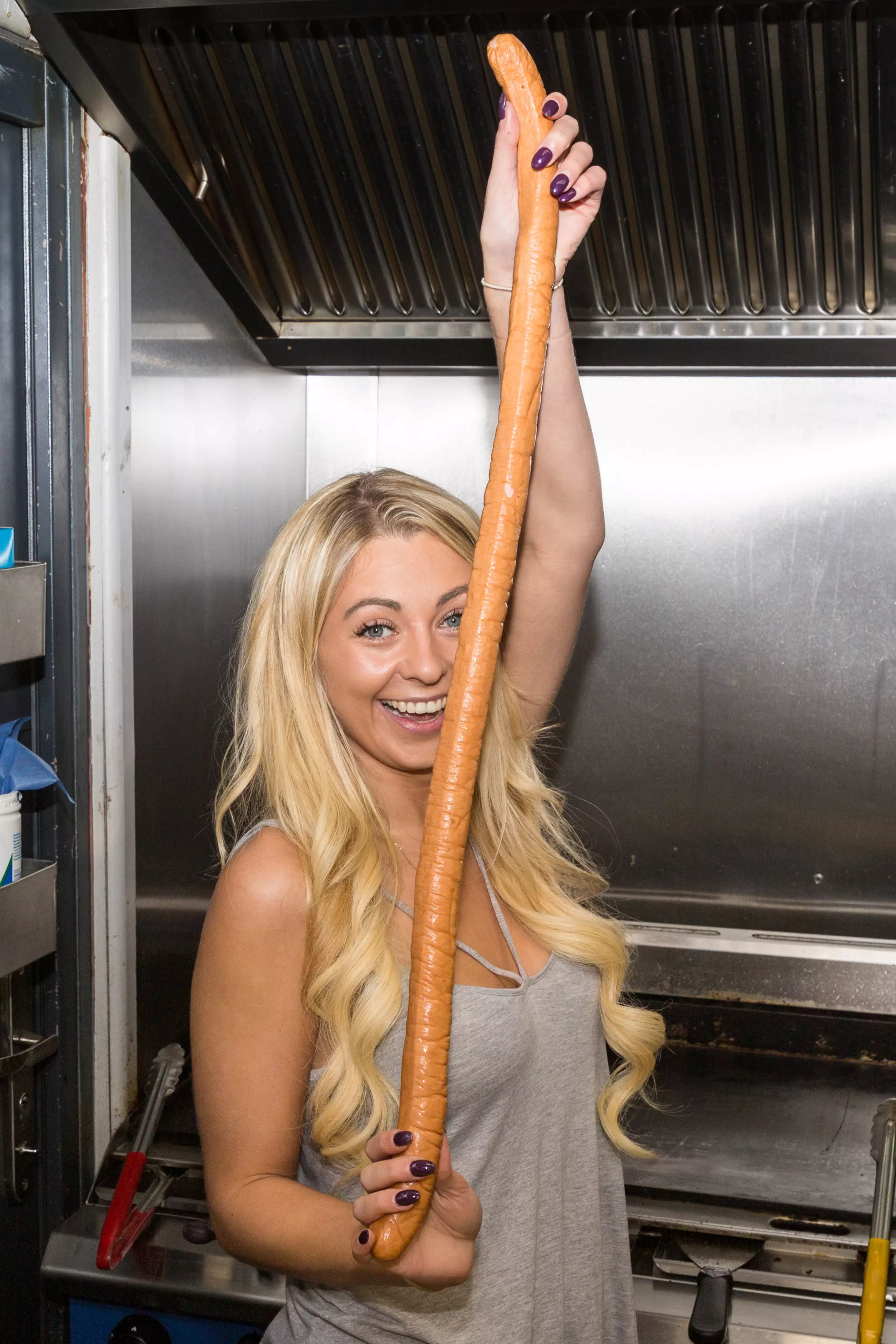 A food blogger has taken on her lengthiest challenge to date and devoured Britain's biggest hotdog. (