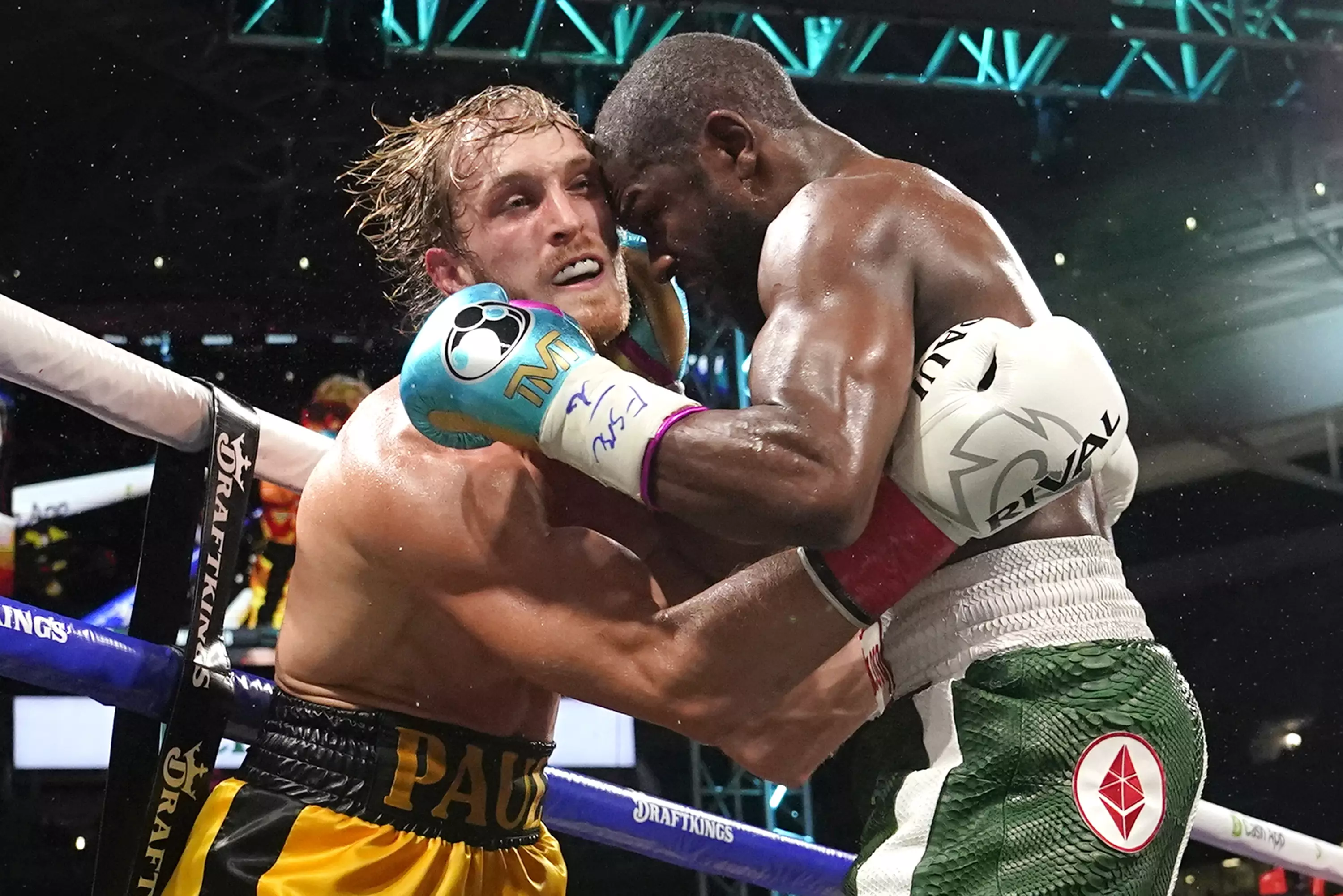 Logan Paul, left, and Floyd Mayweather fight during an exhibition boxing match.