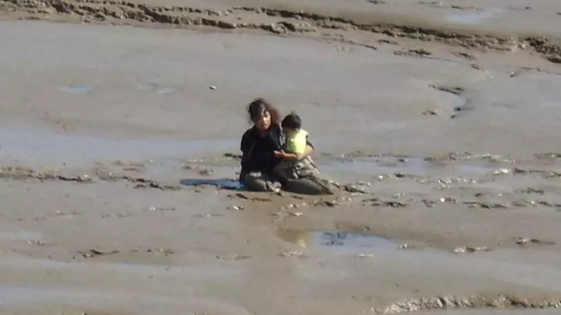 Beachgoers Get Stuck In Mudflats While Trying To Reach The Sea