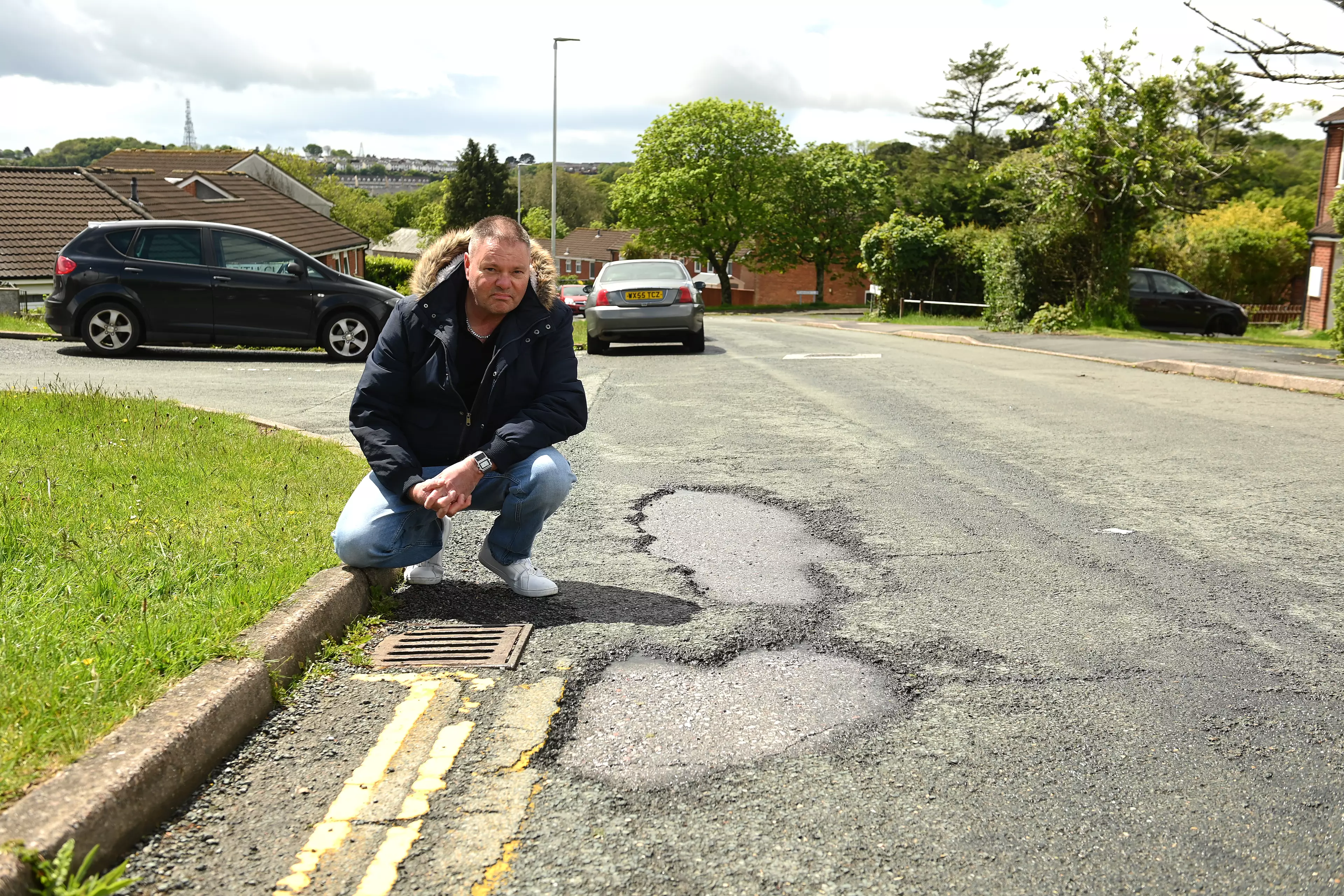 Al Mitchell indicating one of the potholes.