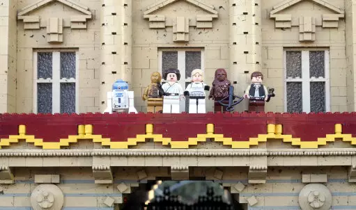 Luke Skywalker and Princess Leia are joined on the balcony of Buckingham Palace by (from left to right) R2-D2, C-3PO, Chewbacca and Han Solo.