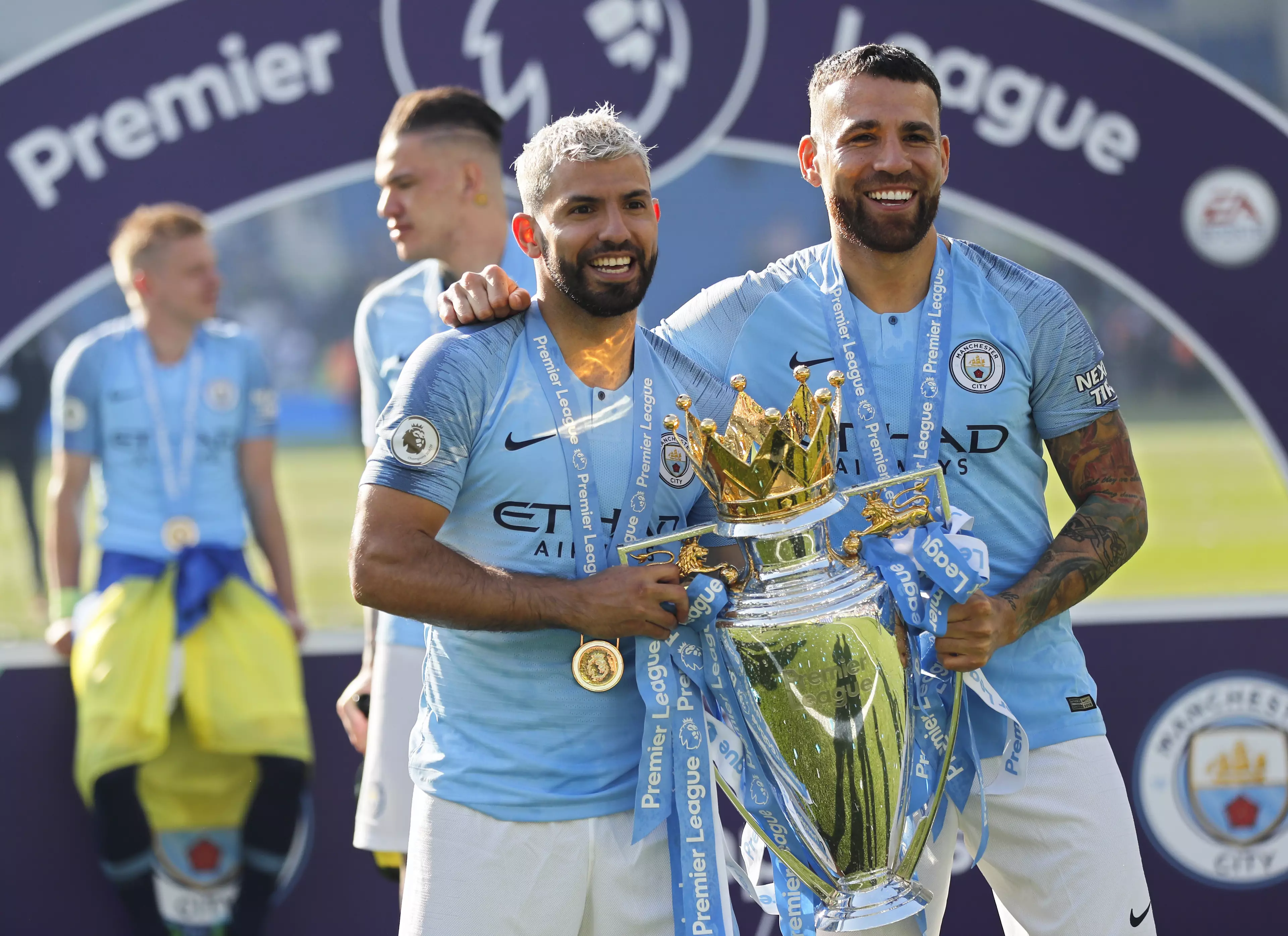 Otamendi (right) and Sergio Aguero celebrate winning the Premier League.
