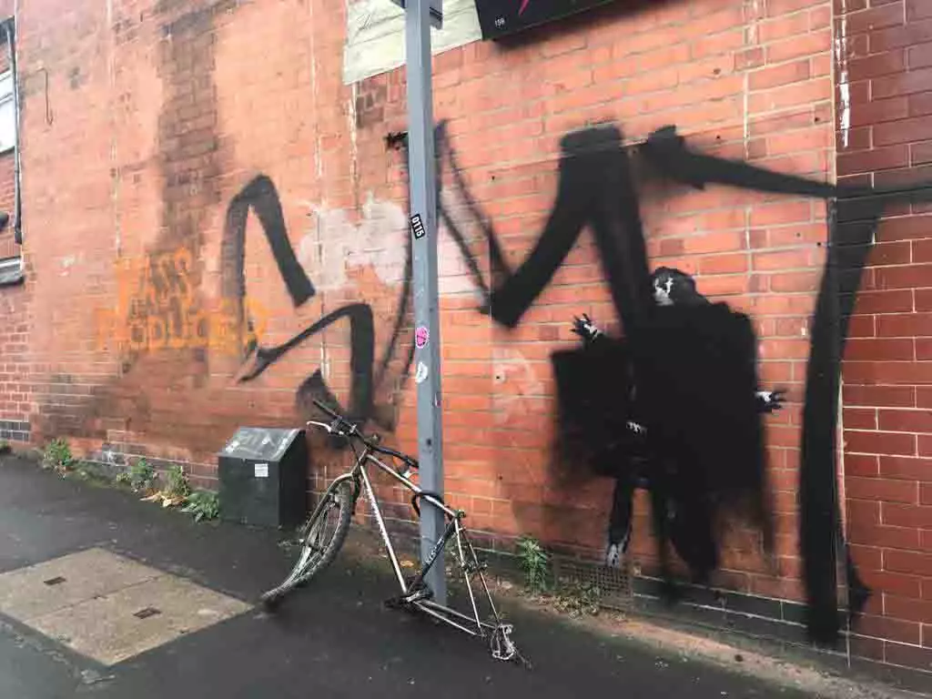 The Banksy artwork has been vandalised twice - but luckily was protected by a perspex screen.