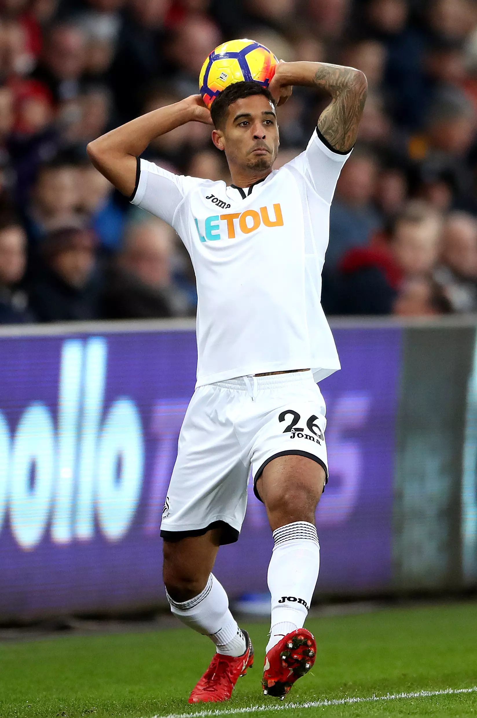 Kyle Naughton takes a throw-in for Swansea City. Image: PA
