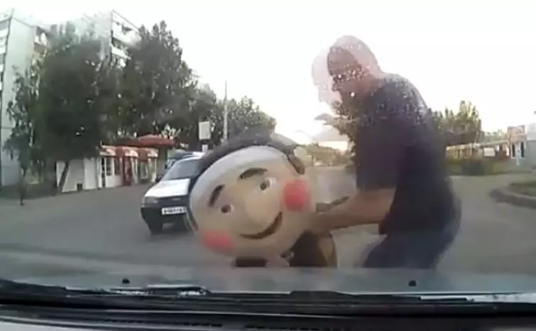 Angry Driver Lets Loose On Giant Head-Masked Man And It's Pretty Funny