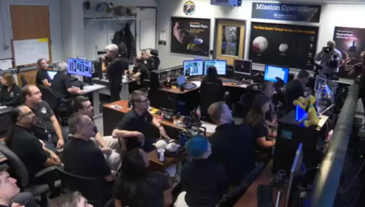 The team of scientists cheered when the first signals were received from the New Horizons craft.