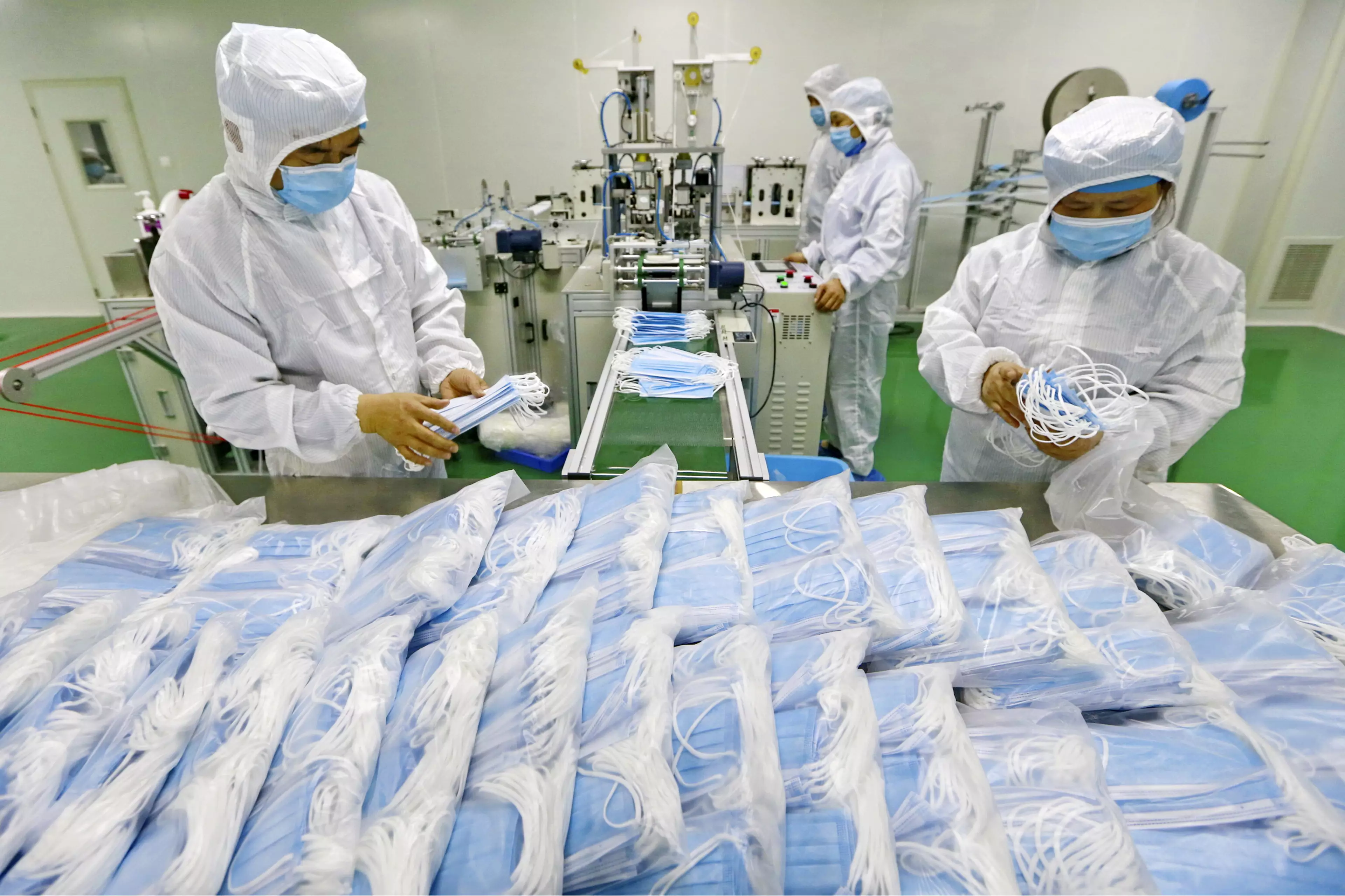 Workers pack surgical masks at a factory in Suining city in southwest China's Sichuan province.