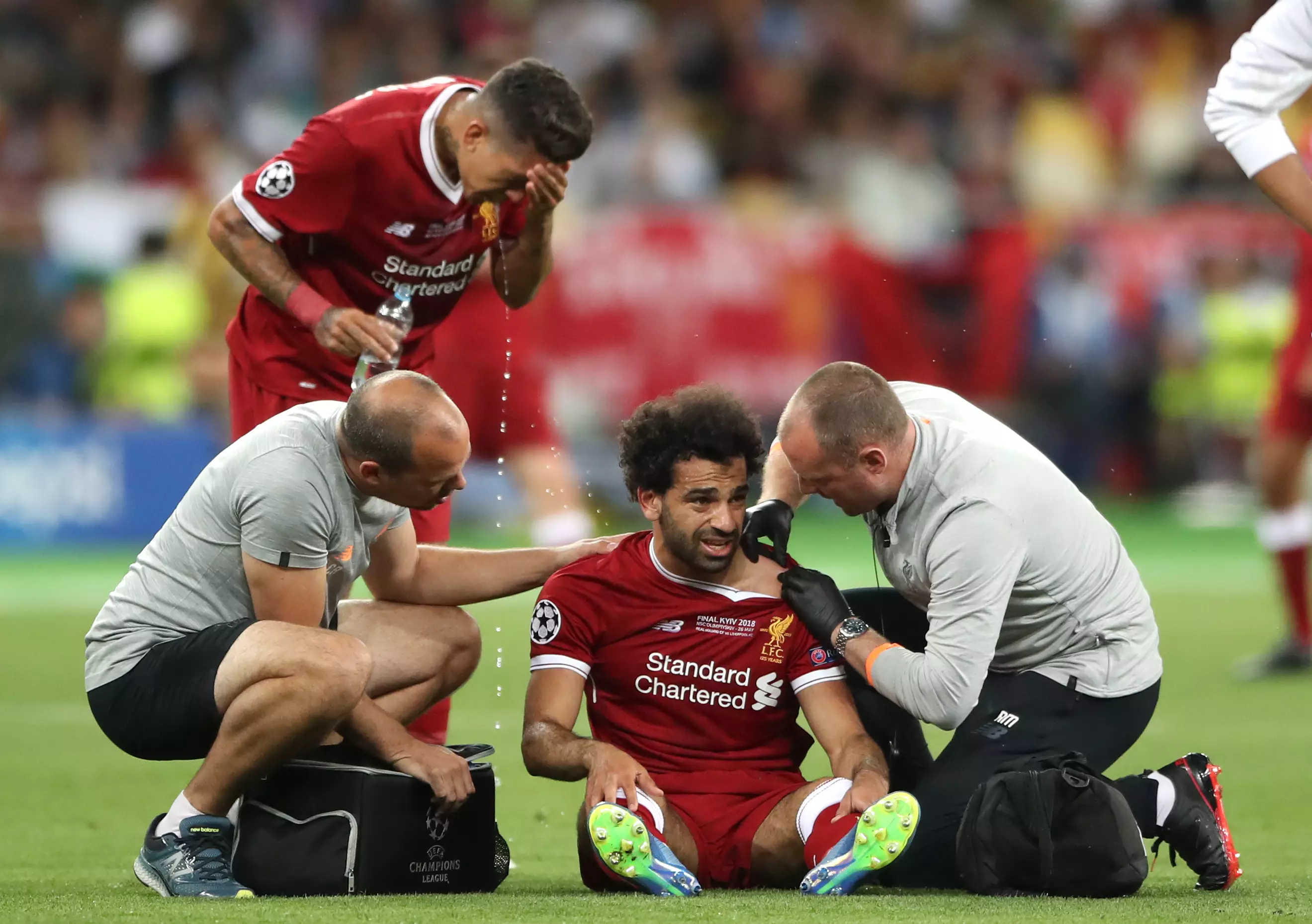 Salah receives treatment on his shoulder. Image: PA