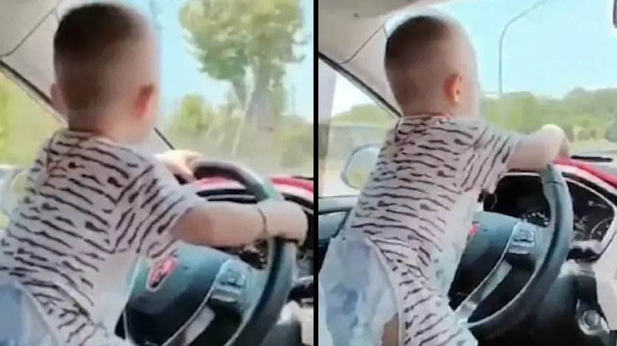 Baby 'Drives' Car On Open Road As Dad Encourages Him To 'Speed Up'