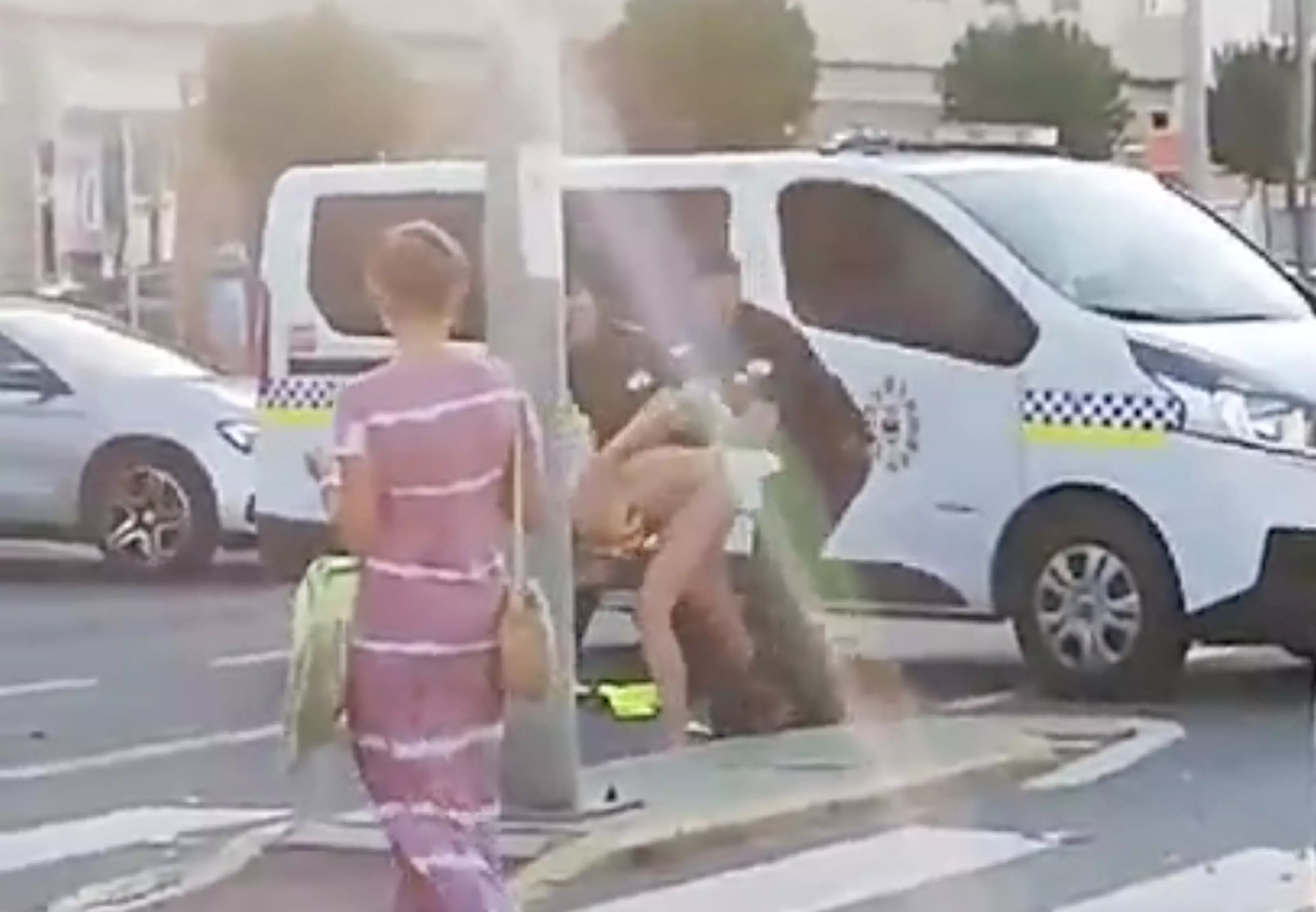 The woman can be seen to resist arrest in the footage.