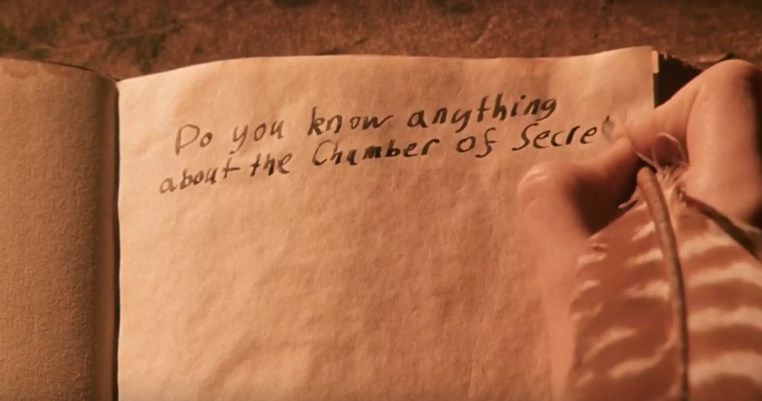 Harry Potter chats to Tom Riddle through the diary, not knowing it's his enemy Voldemort.