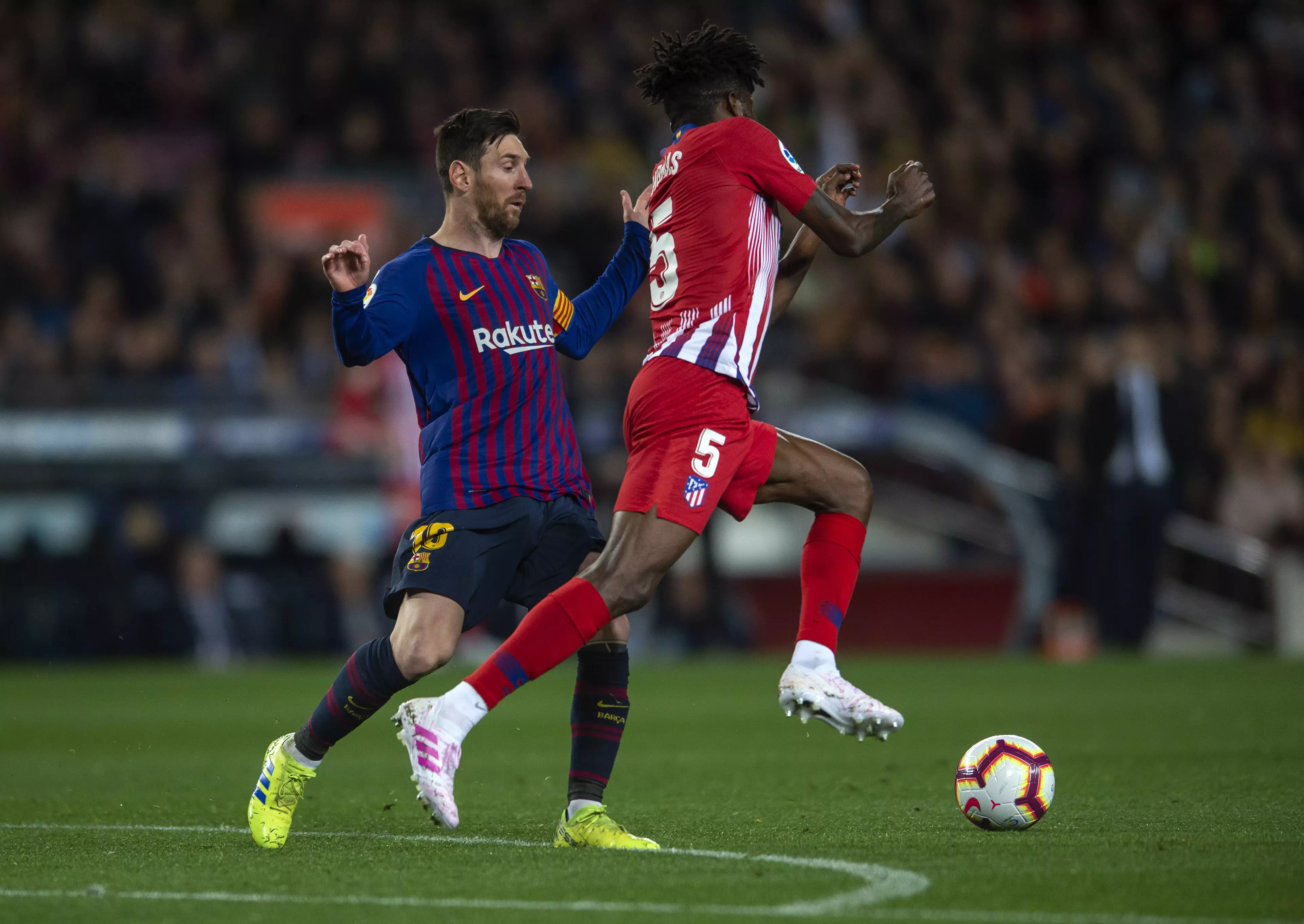 Partey wins the ball off Messi. Image: PA Images