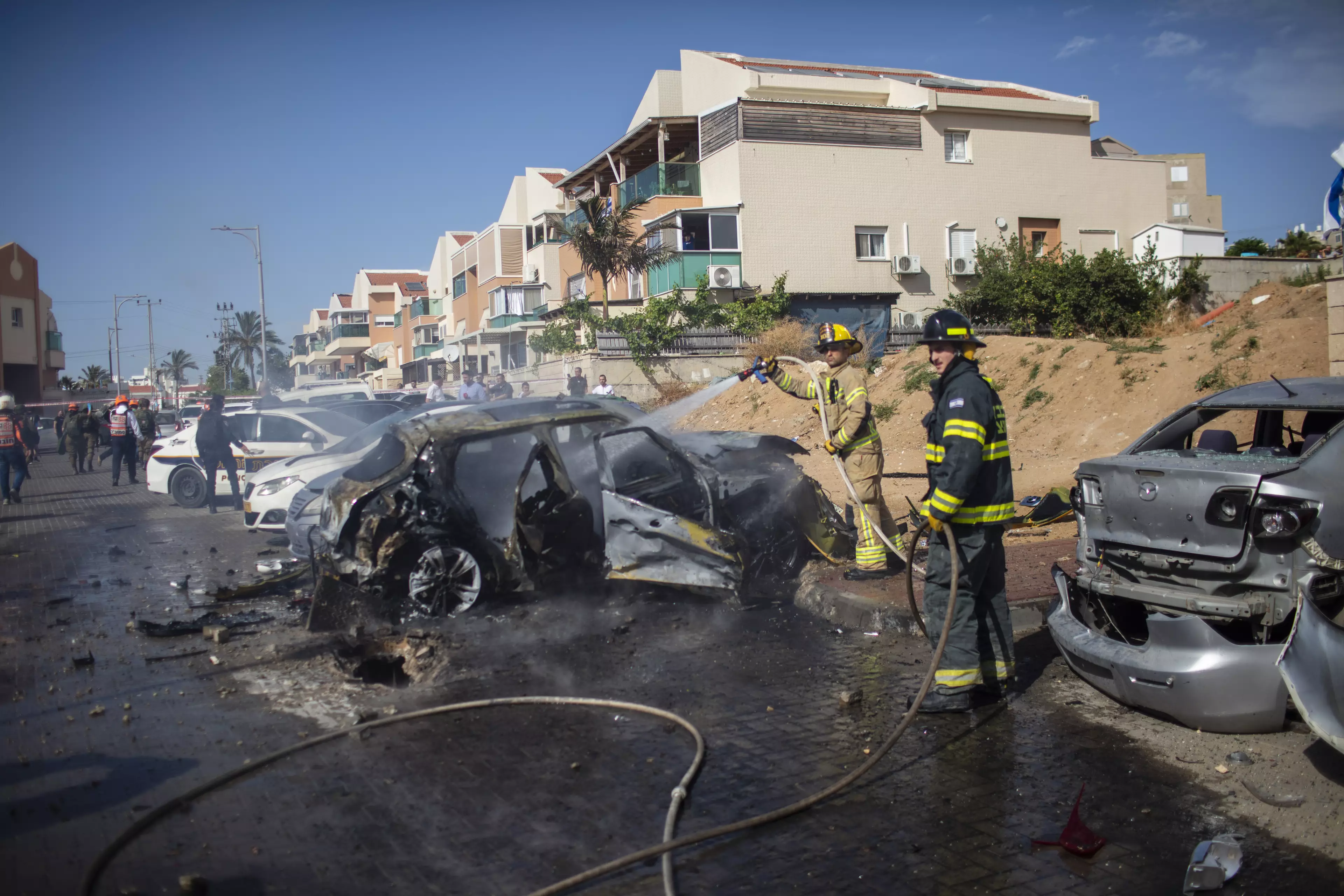 Firefighters extinguish blaze caused by a rocket fired from Gaza Strip towards Israel.