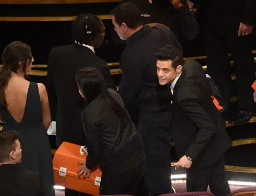 Rami Malek, recipient of the award for best performance by an actor in a leading role, speaks with medical staff after a fall at the Oscars.