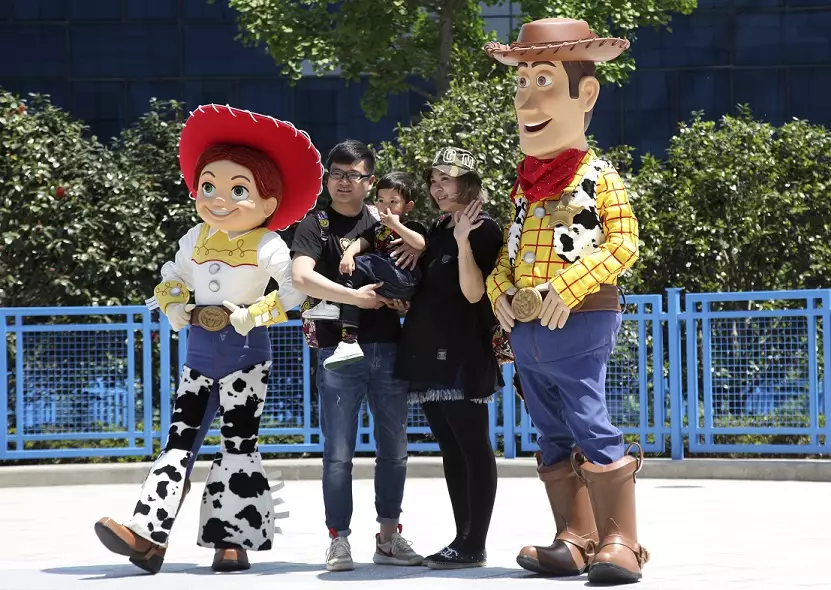 Woody and Jessie pose with a family at Shanghai Disneyland.