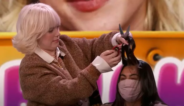 Eilish cutting hair with all the confidence of somebody who has never done it before.