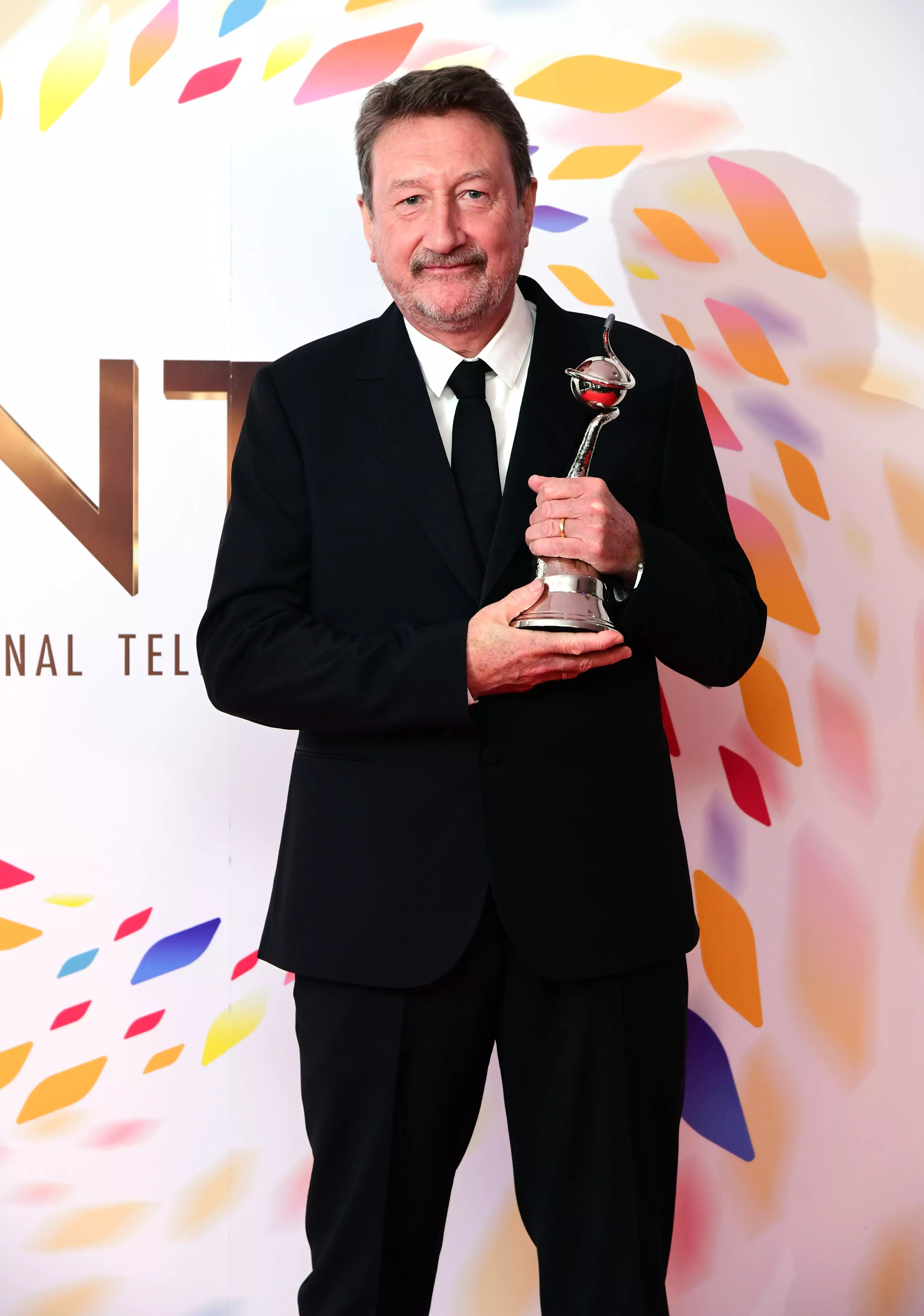 Steven Knight with the award for Best Drama for Peaky Blinders at the 2020 NTAs.