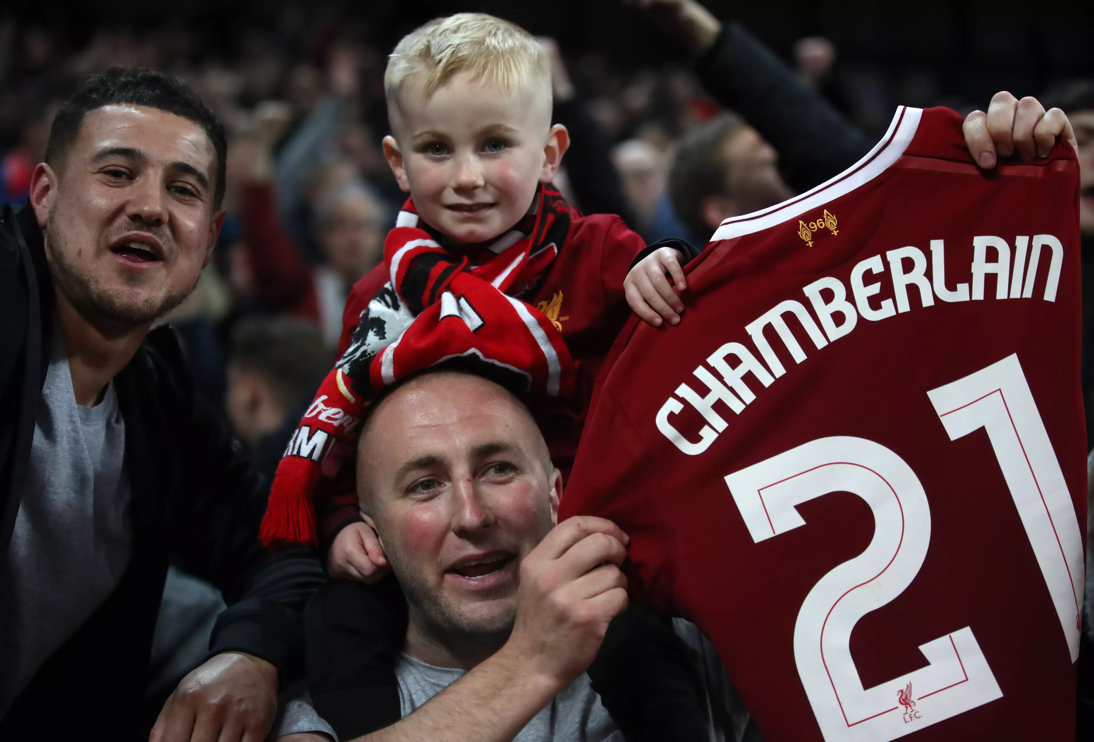 Liverpool fan holds up Oxlade-Chamberlain's shirt. Image: PA