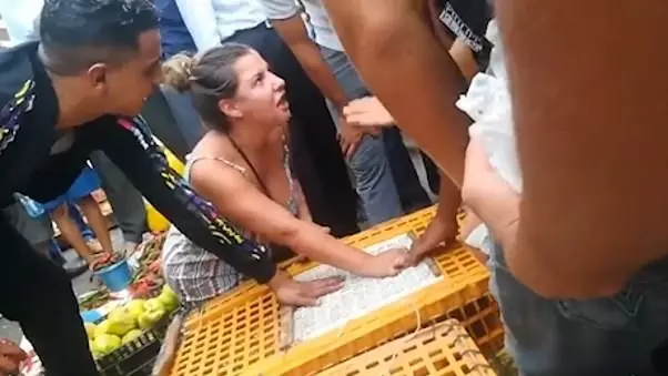 Woman Bites Moroccan Chicken Seller's Hand As She Tries To Free Birds
