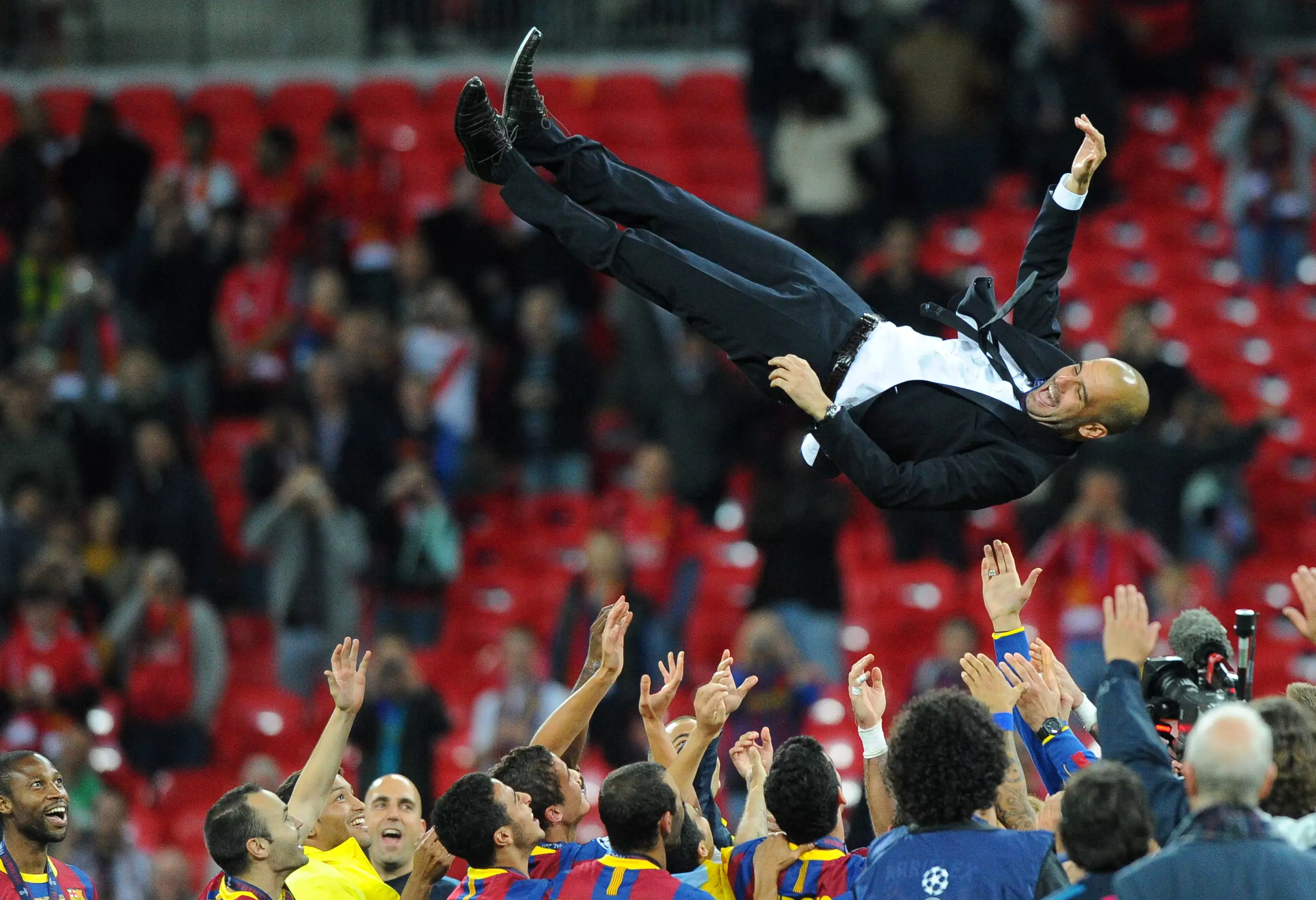 Guardiola is thrown into the air by his Barcelona squad after winning the competition in 2011. (Image