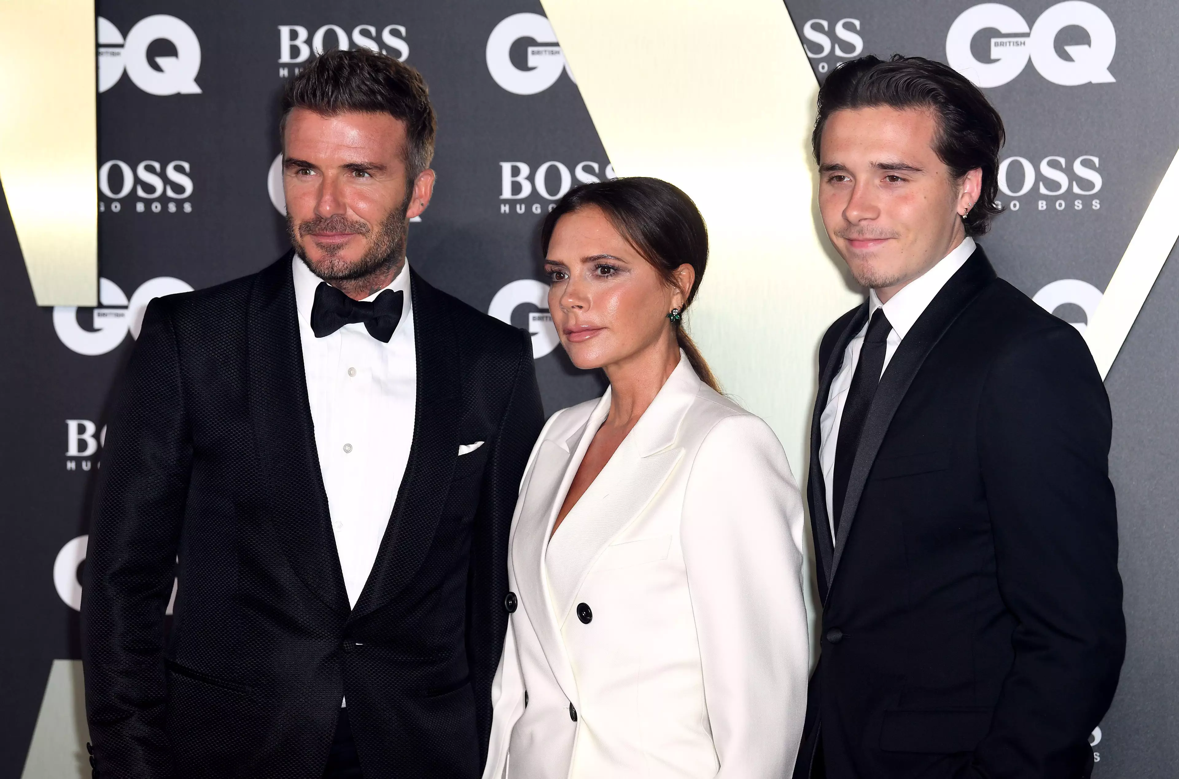 (Left To Right) David, Victoria and Brooklyn Beckham. (