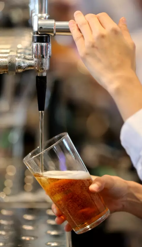 Beer being poured at a Wetherspoon pub.
