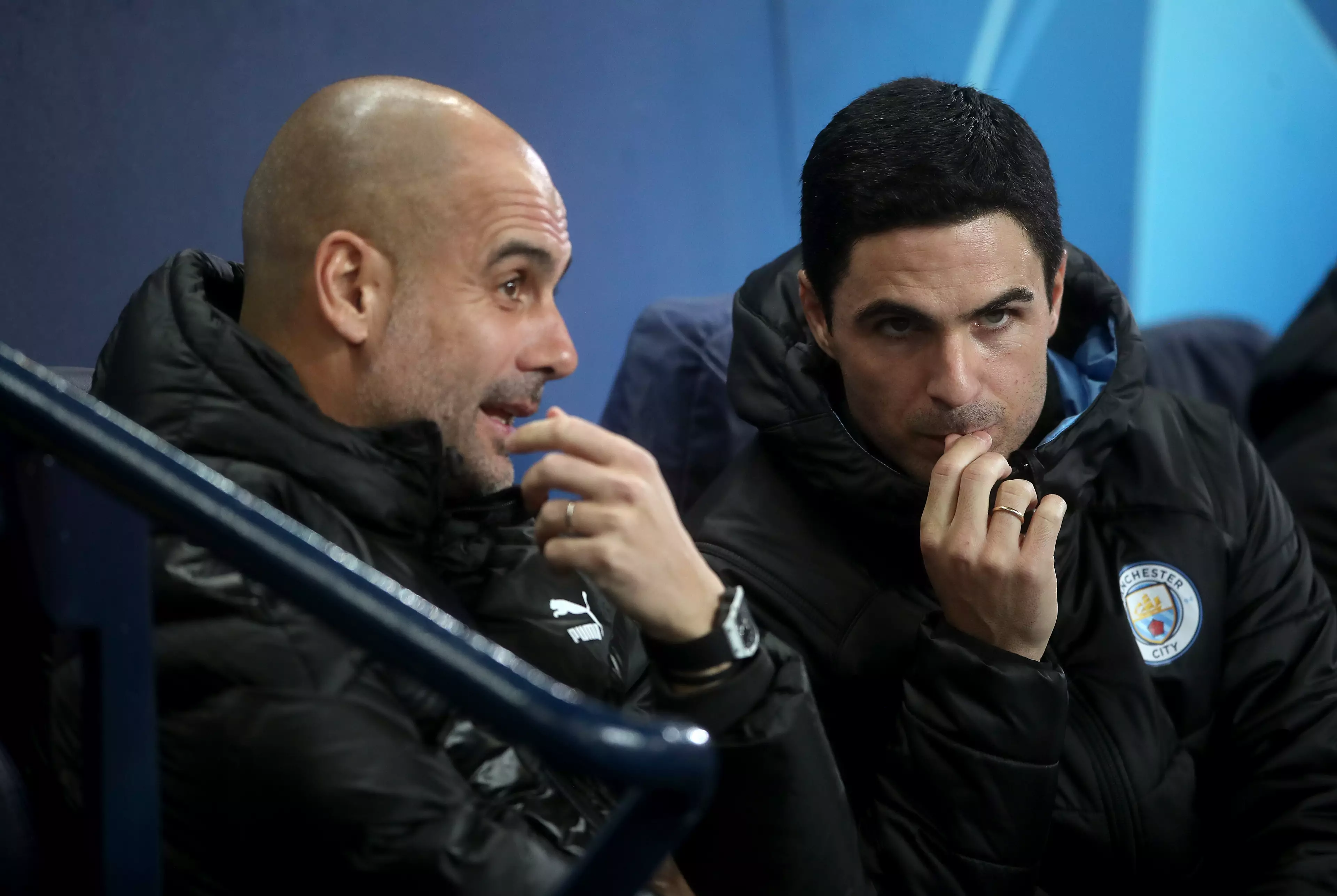 Arteta talking to Guardiola on the City bench. Image: PA Images