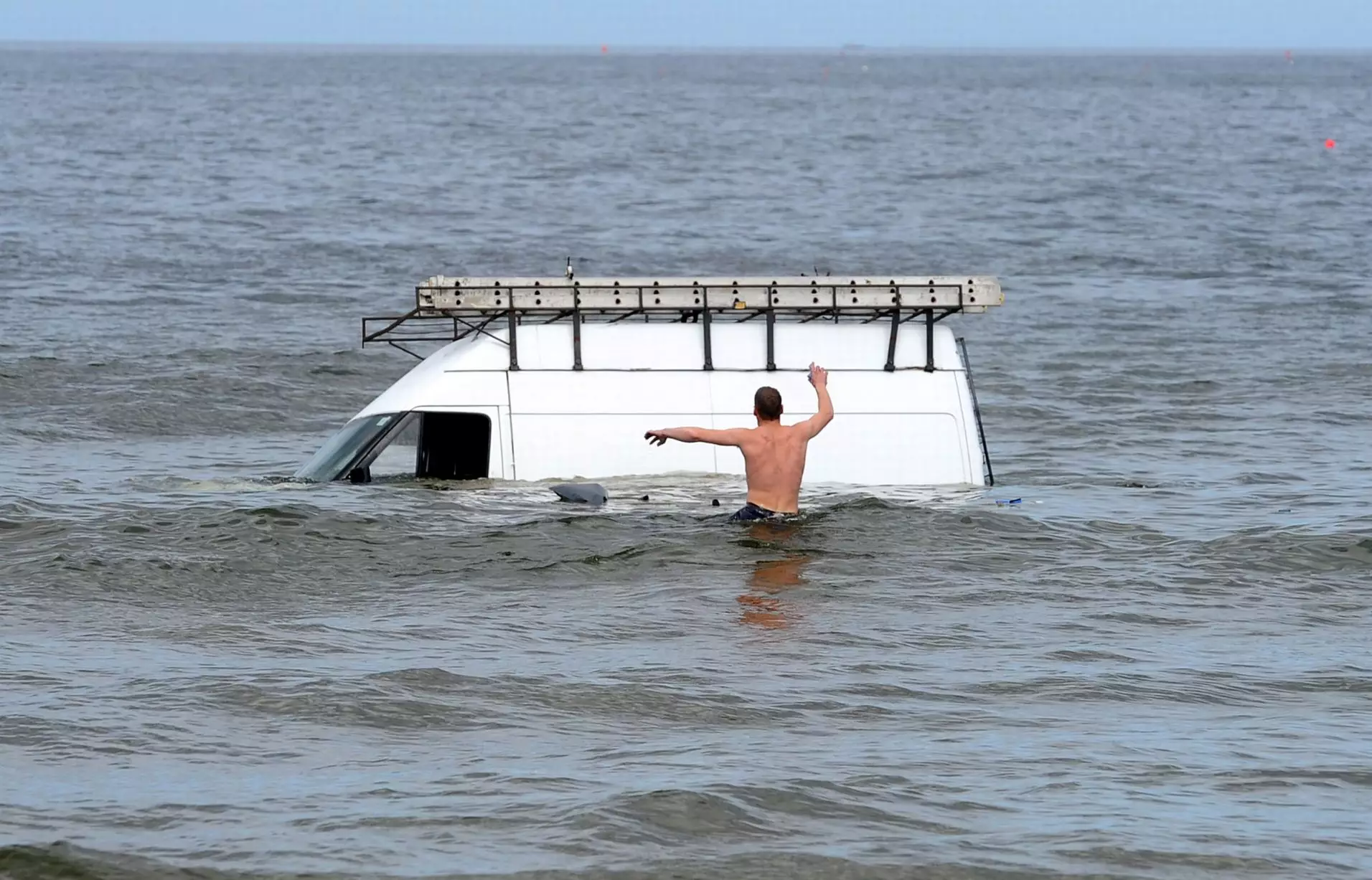 The man's van became stuck when the tide came in.