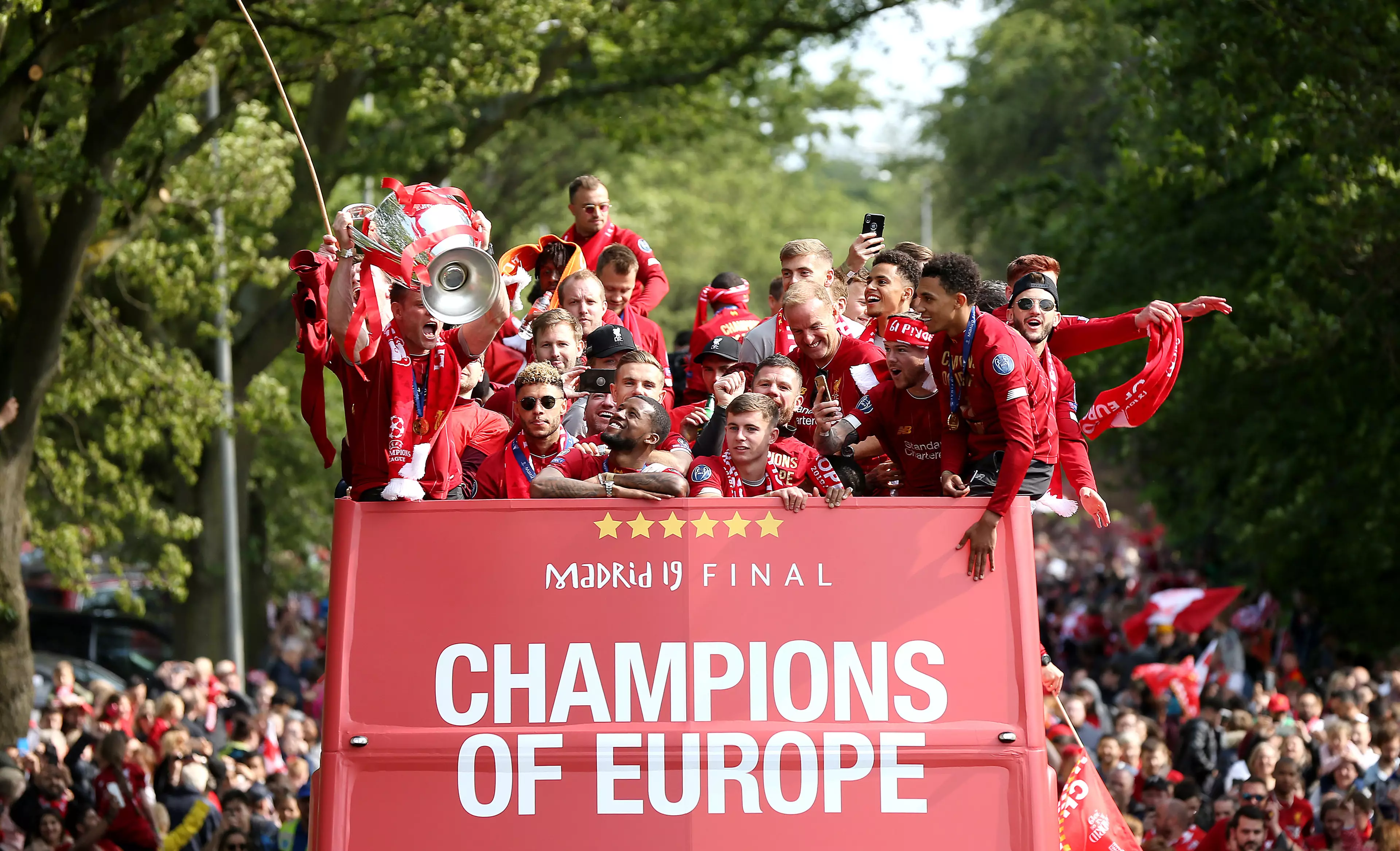 Liverpool parade their trophy back home. Image: PA Images