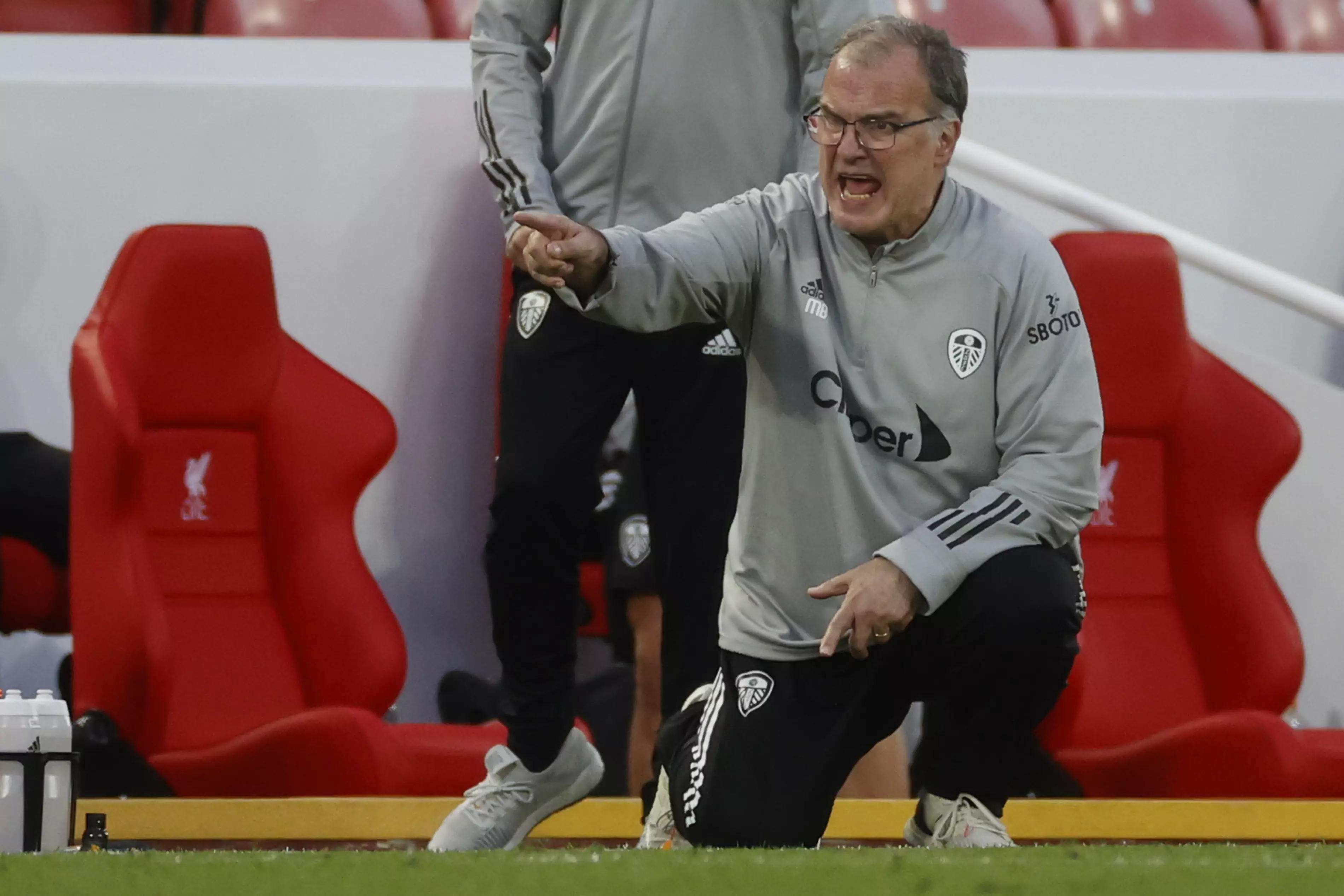 Bielsa down on his haunches during the Liverpool game. Image: PA Images