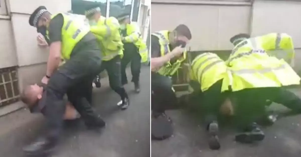 Police Officer 'Repeatedly Punches' Manchester United Fan As He Lies On Ground