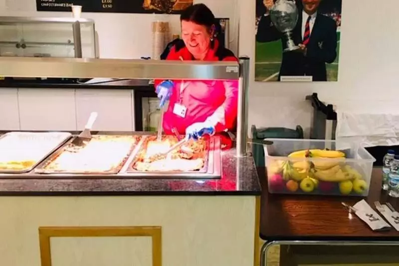 A member of staff serves food. Image: Crystal Palace/Croydon Council