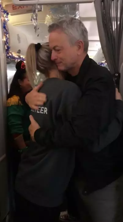 The actor welcoming families on board the plane.
