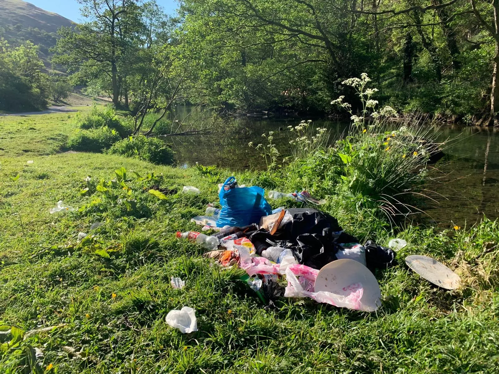 Piles of rubbish left next to a stream in the Peak District.