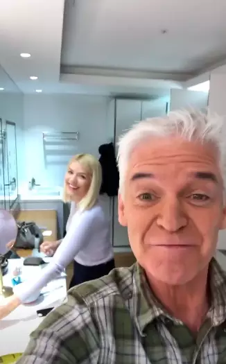Holly could be seen doing her makeup in the background (