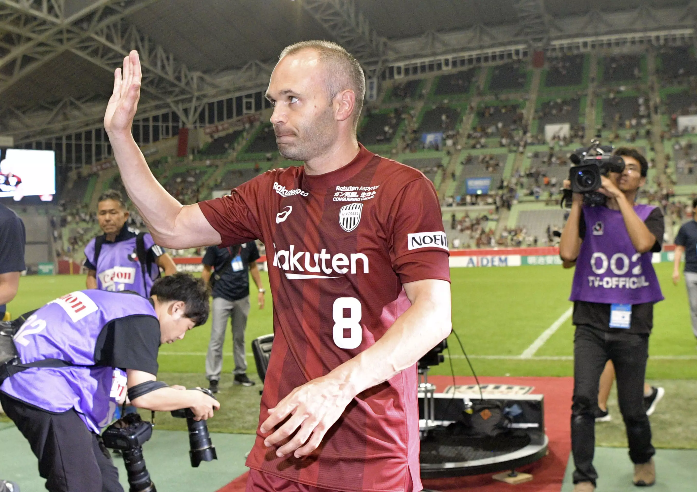 Iniesta waves to the fans. Image: PA