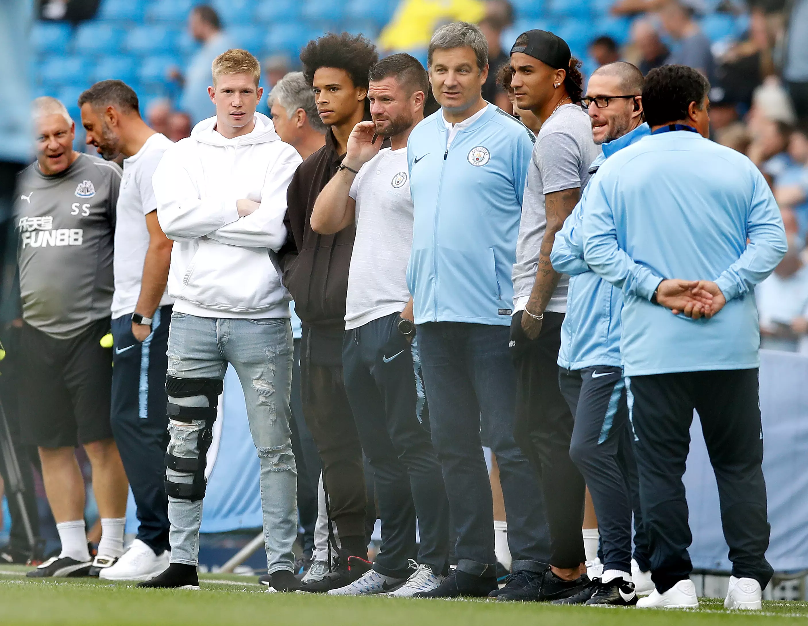 De Bruyne watching on in his knee brace. Image: PA Images