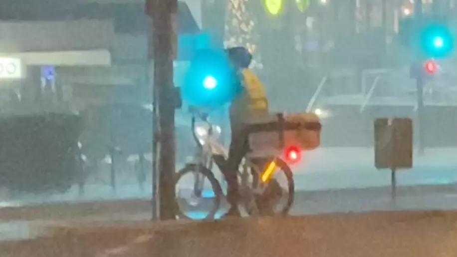 Aussie Pizza Delivery 'Legend' Seen Transporting Food During Massive Storm