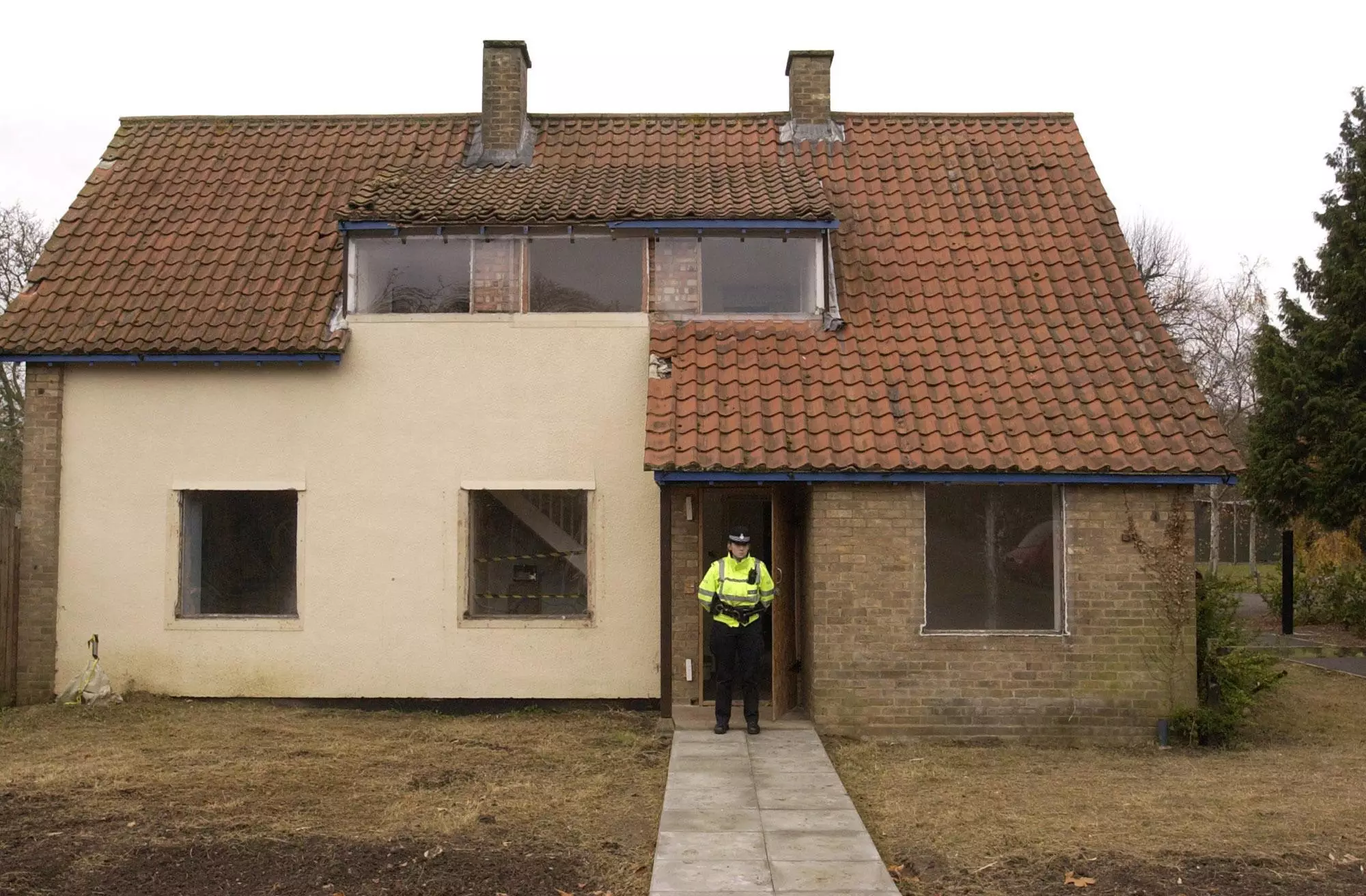 A police officer stands outside Ian Huntley's home.
