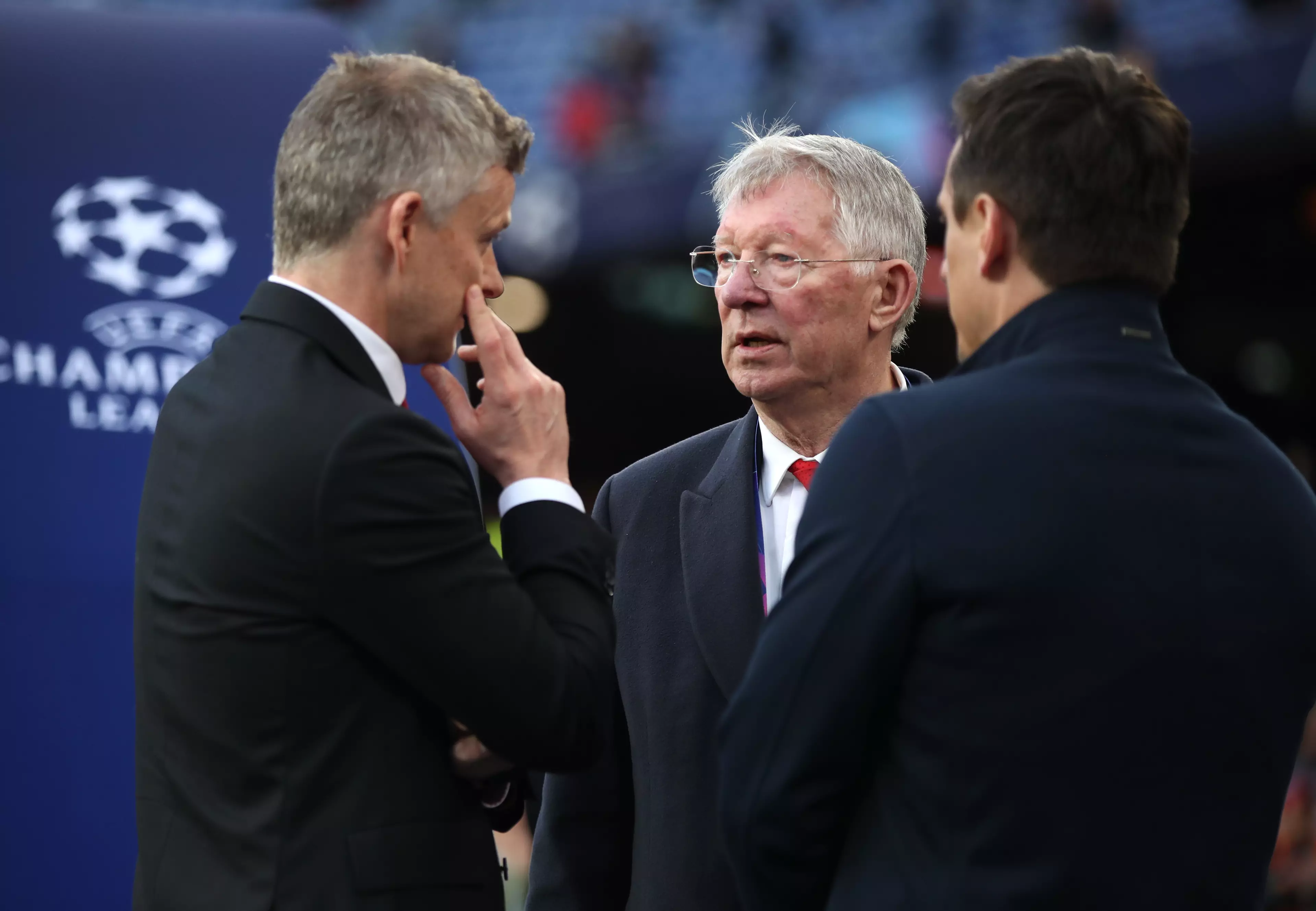 Ferguson talking to former players Ole Gunnar Solskjaer and Gary Neville. Image: PA Images