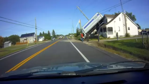 Incredible Footage Shows The Moment A Truck Flips And Lands On A House