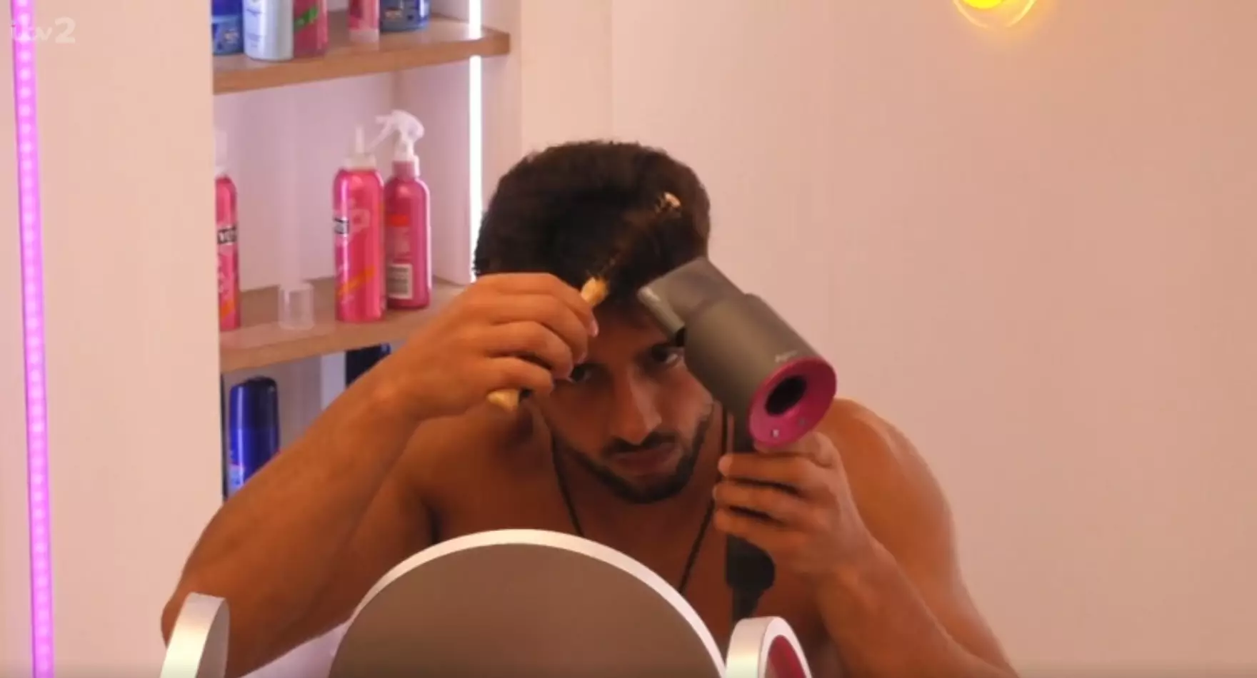 Marvin curls his quiff with a round brush and hairdryer.
