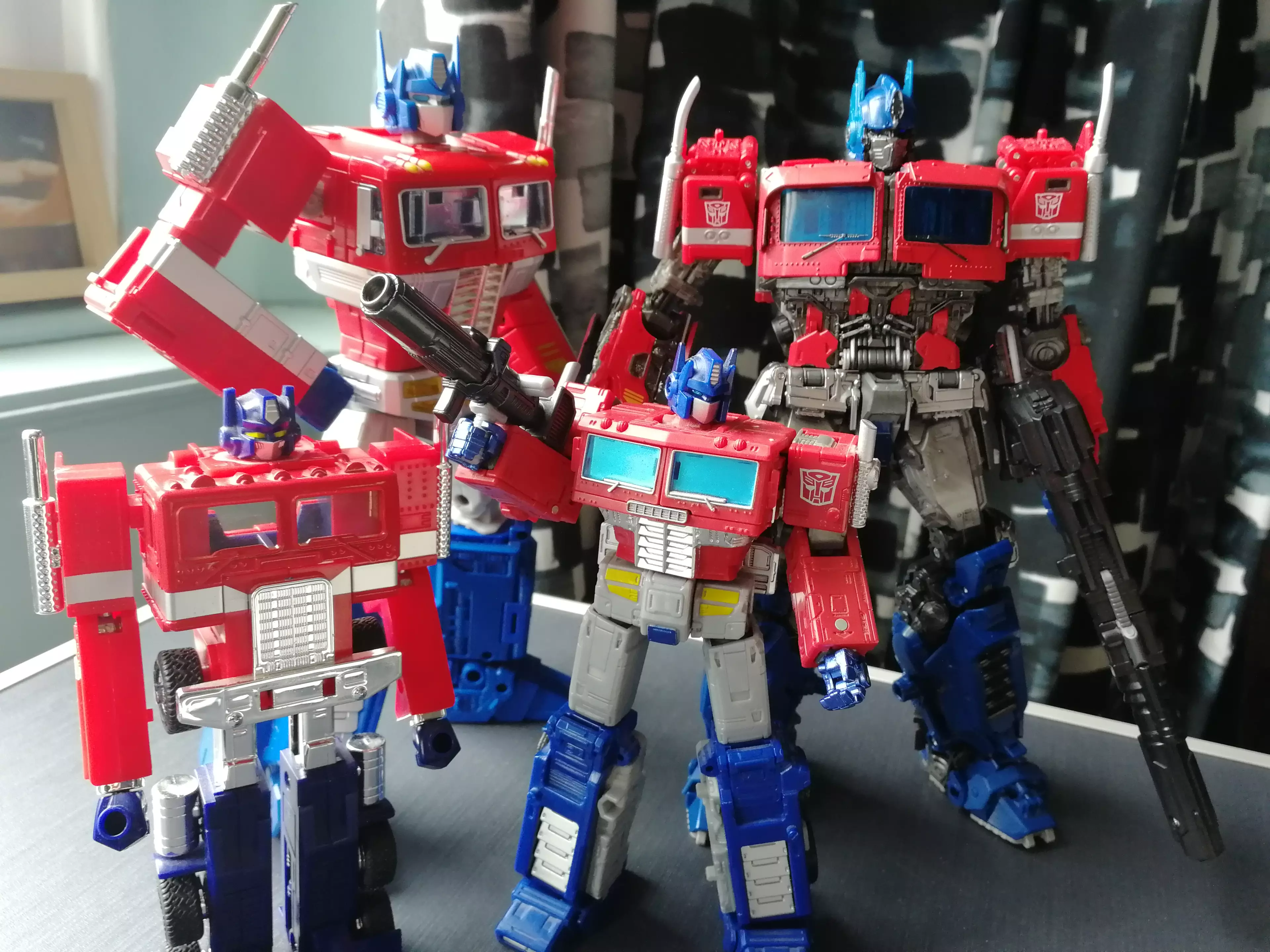 MPM-12 Optimus Prime (back, right) next to MP10, Earthrise Optimus Prime, and the classic Prime from the 1980s / credit: the author