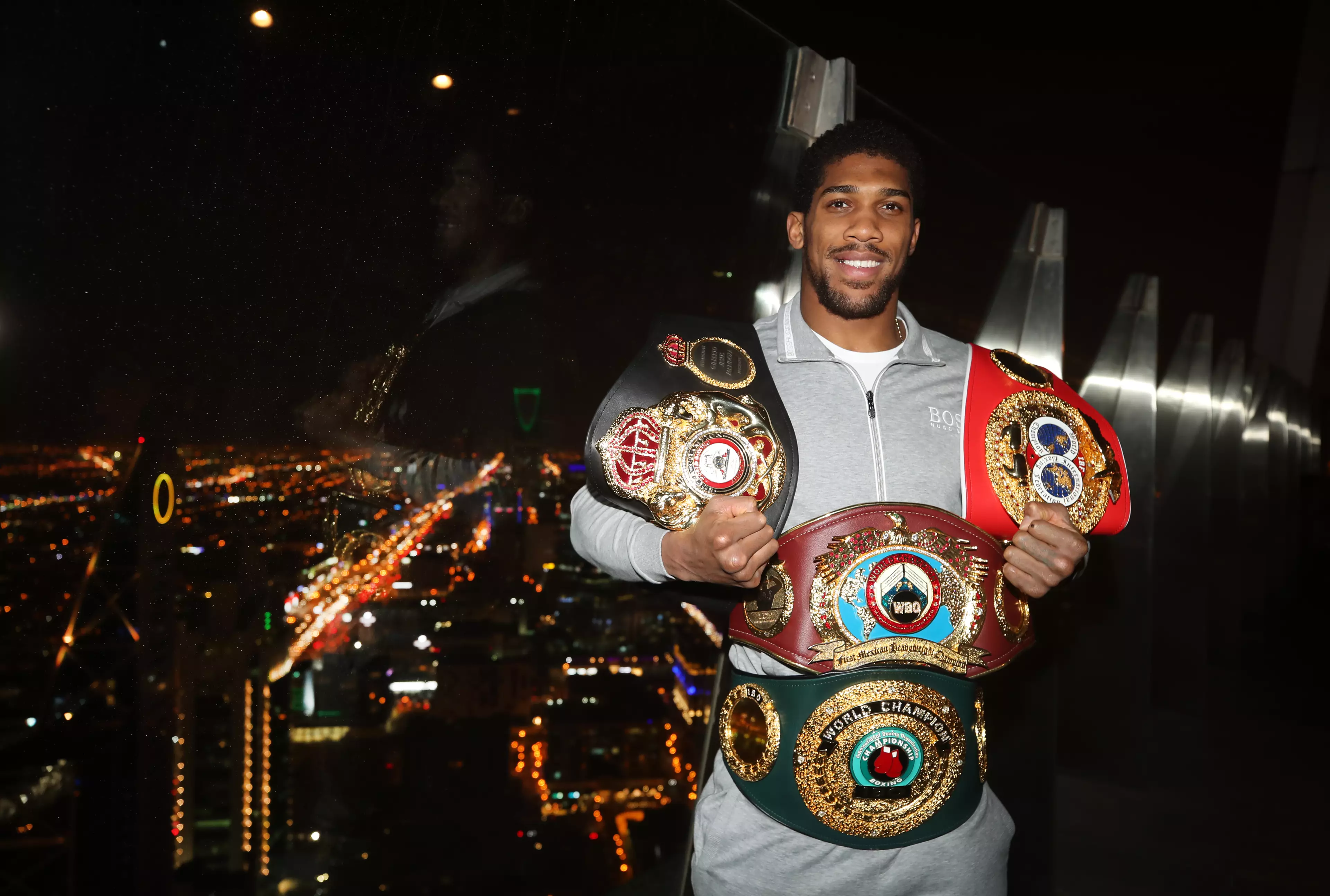 Joshua shows off the belts he won back. Image: PA Images